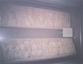 A picture of some white walls with some carvings.